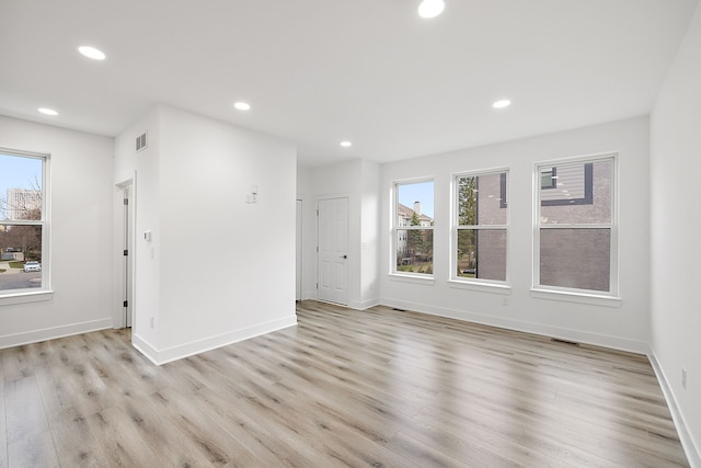 empty room with a healthy amount of sunlight and light wood-type flooring