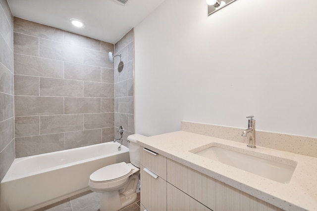 full bathroom featuring tiled shower / bath, tile patterned flooring, vanity, and toilet