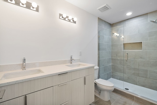 bathroom with tile patterned flooring, vanity, an enclosed shower, and toilet