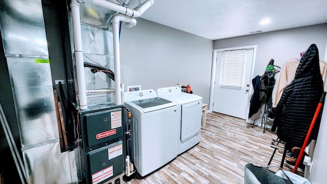 491 Bitter Creek Ln, Pierson, MI 49339 - laundry area featuring washing machine and dryer and light wood-style floors