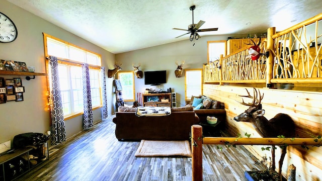 491 Bitter Creek Ln, Pierson, MI 49339 - living area featuring vaulted ceiling, a ceiling fan, wood finished floors, and a textured ceiling