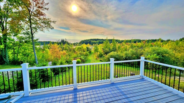 491 Bitter Creek Ln, Pierson, MI 49339 - deck featuring a wooded view and a lawn