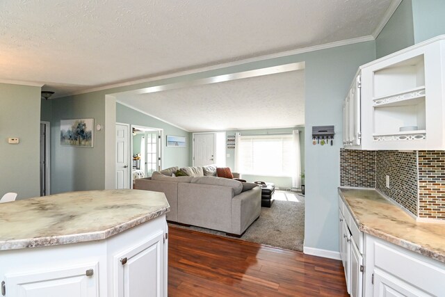 kitchen featuring a textured ceiling, white cabinetry, and dark wood-type flooring