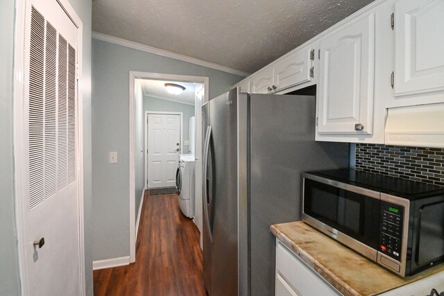 kitchen featuring lofted ceiling, white cabinets, dark hardwood / wood-style floors, tasteful backsplash, and stainless steel appliances