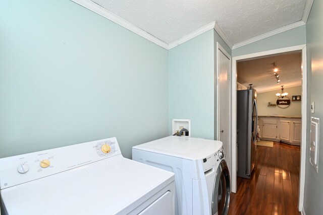laundry area with a textured ceiling, separate washer and dryer, dark hardwood / wood-style floors, and ornamental molding