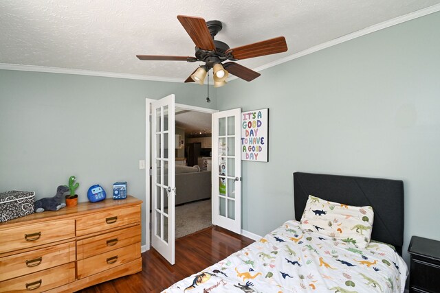 bedroom featuring ceiling fan, ornamental molding, dark wood-type flooring, and french doors