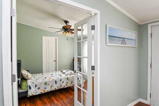 bedroom with ceiling fan, crown molding, wood-type flooring, and a textured ceiling