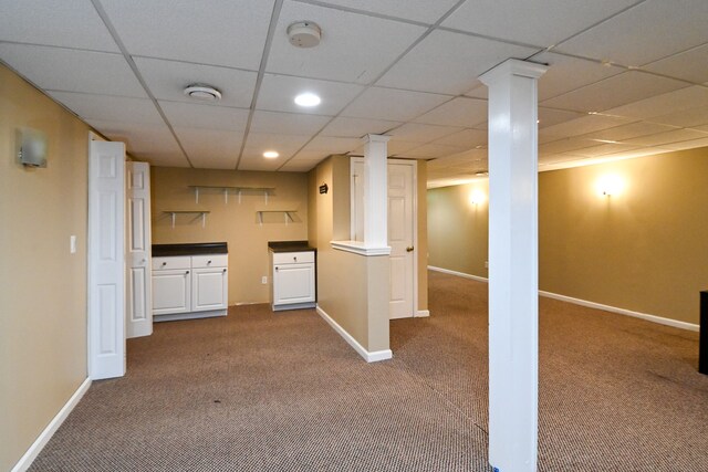 basement with carpet flooring and a drop ceiling