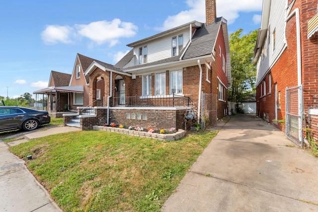 view of front of property with covered porch and a front lawn