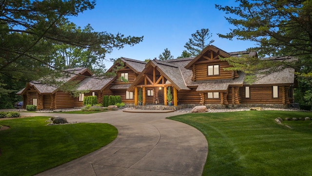 log-style house with a front lawn