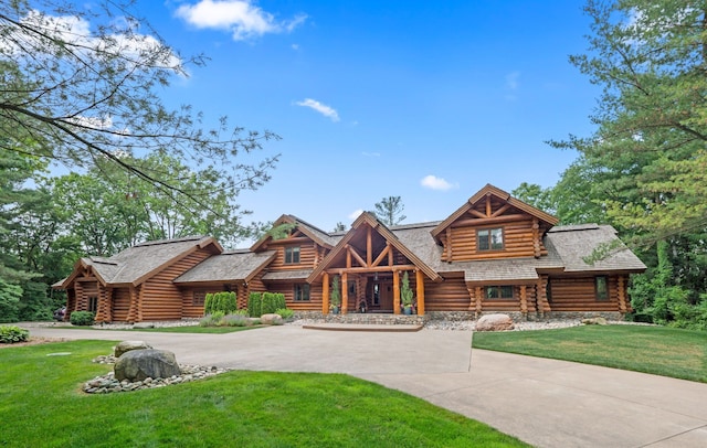 log cabin with a front yard