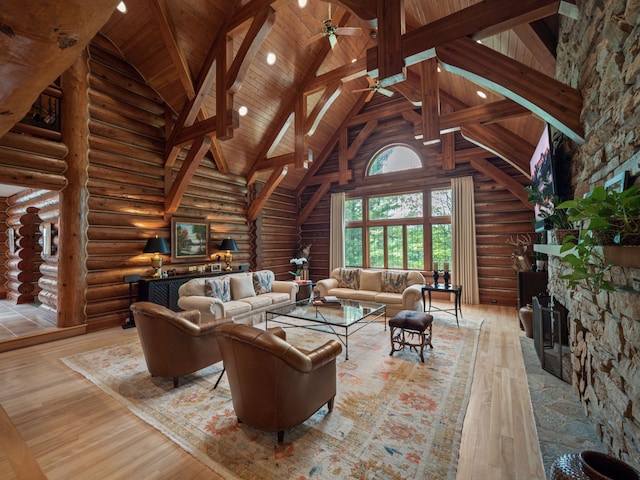 living room featuring log walls, high vaulted ceiling, wood ceiling, and light wood-type flooring