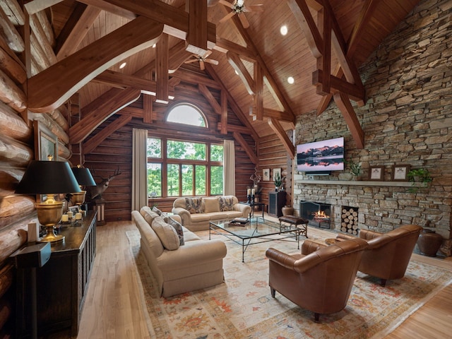 living room featuring wooden ceiling, high vaulted ceiling, ceiling fan, light wood-type flooring, and a fireplace