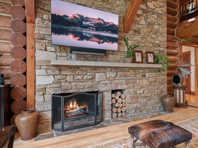 room details with a fireplace, hardwood / wood-style floors, and log walls