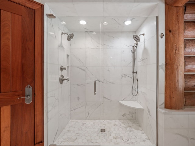 bathroom featuring a shower with shower door