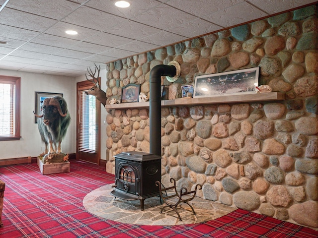 unfurnished living room with a wood stove and carpet