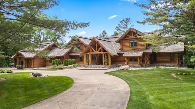 log home featuring a front lawn