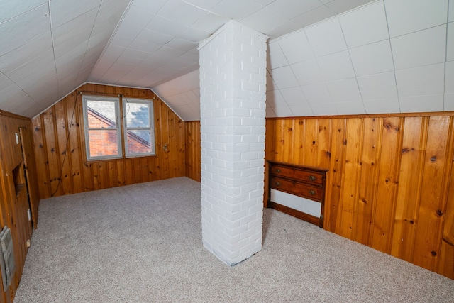 bonus room featuring wood walls, carpet floors, and vaulted ceiling