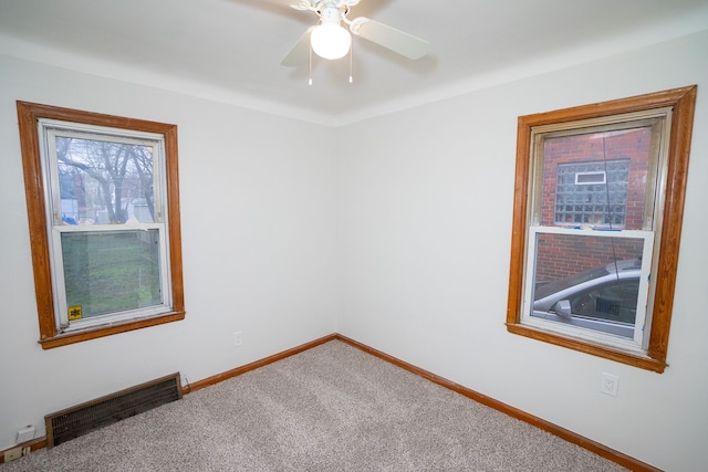 spare room featuring carpet and ceiling fan