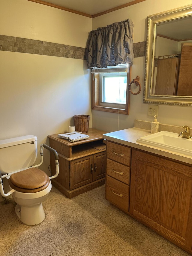 bathroom featuring vanity, toilet, and ornamental molding