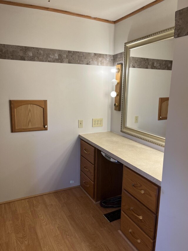 bathroom with vanity, wood-type flooring, and ornamental molding