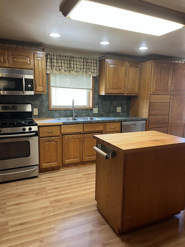 8181 15 Mile Rd, Evart, MI 49631 - kitchen with appliances with stainless steel finishes, a sink, butcher block countertops, light wood finished floors, and recessed lighting
