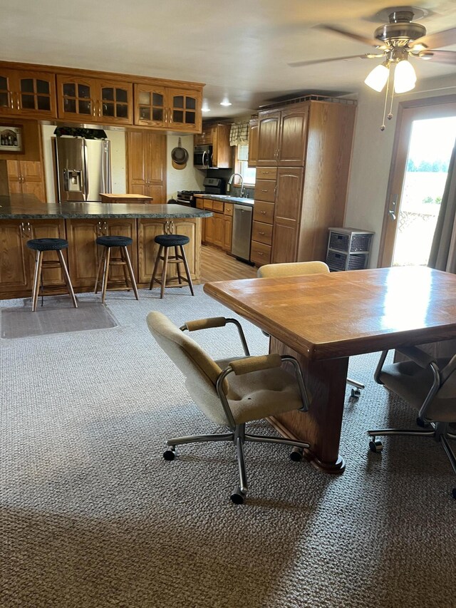 8181 15 Mile Rd, Evart, MI 49631 - dining room with plenty of natural light, ceiling fan, and light colored carpet
