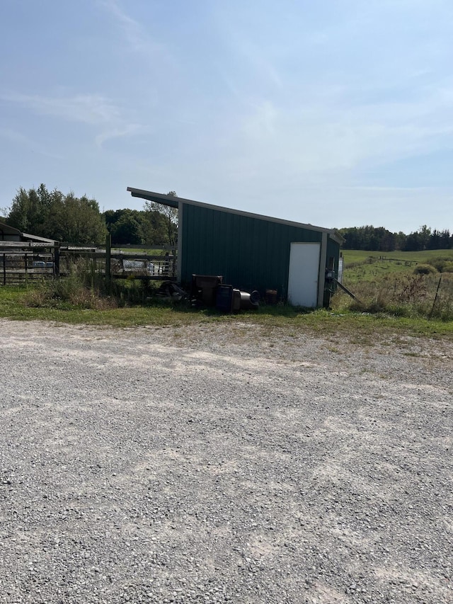 view of outdoor structure with a rural view