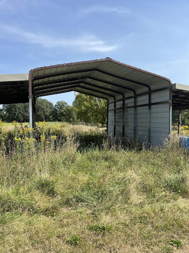 view of vehicle parking featuring a carport