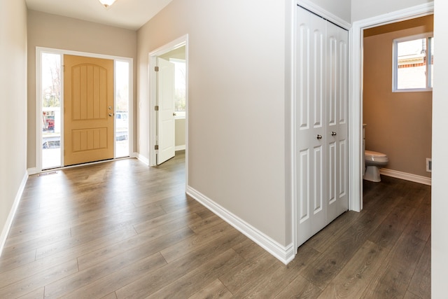 entryway featuring baseboards and wood finished floors