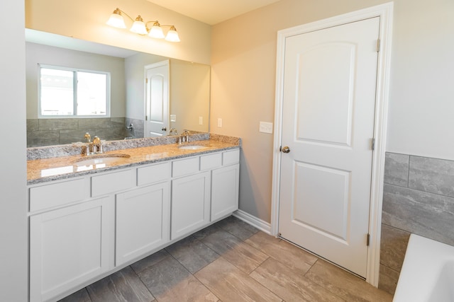 full bath featuring double vanity and a sink