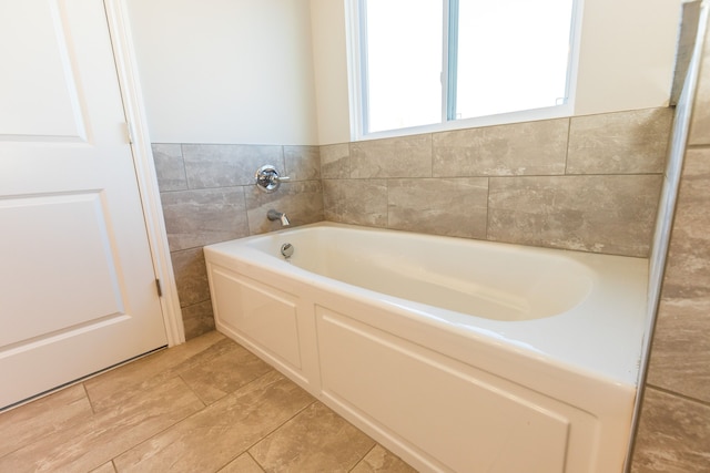 full bath with tile walls and a bath