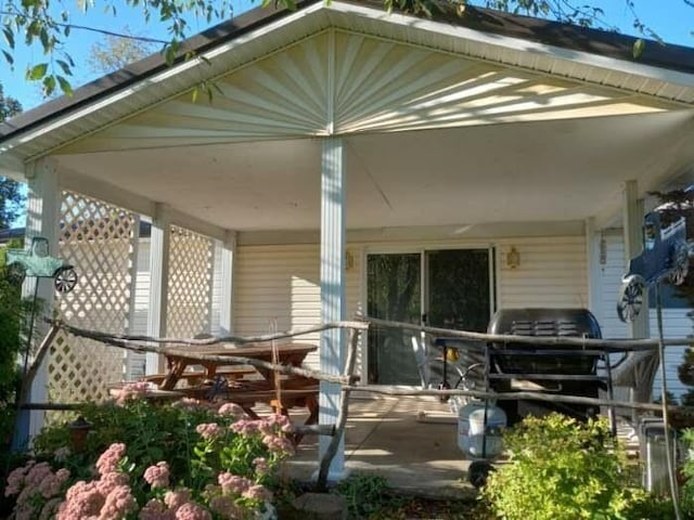 rear view of house featuring covered porch