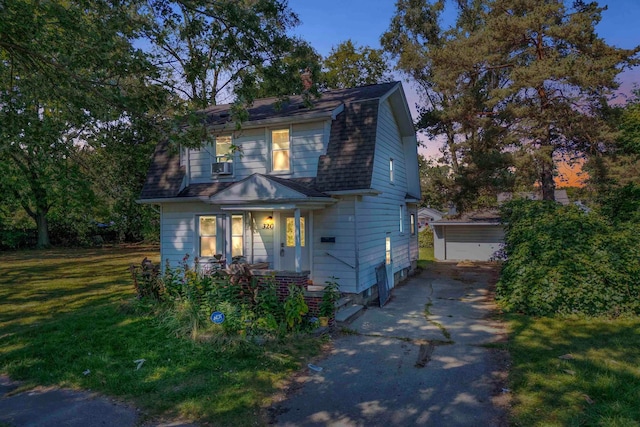 view of front of home featuring a yard, a garage, and an outdoor structure