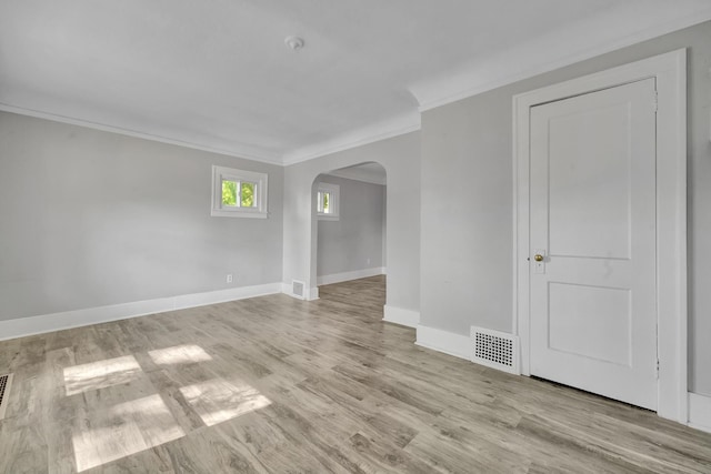 spare room featuring light hardwood / wood-style flooring and ornamental molding