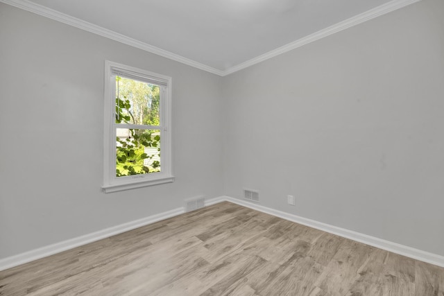 unfurnished room featuring crown molding and light wood-type flooring