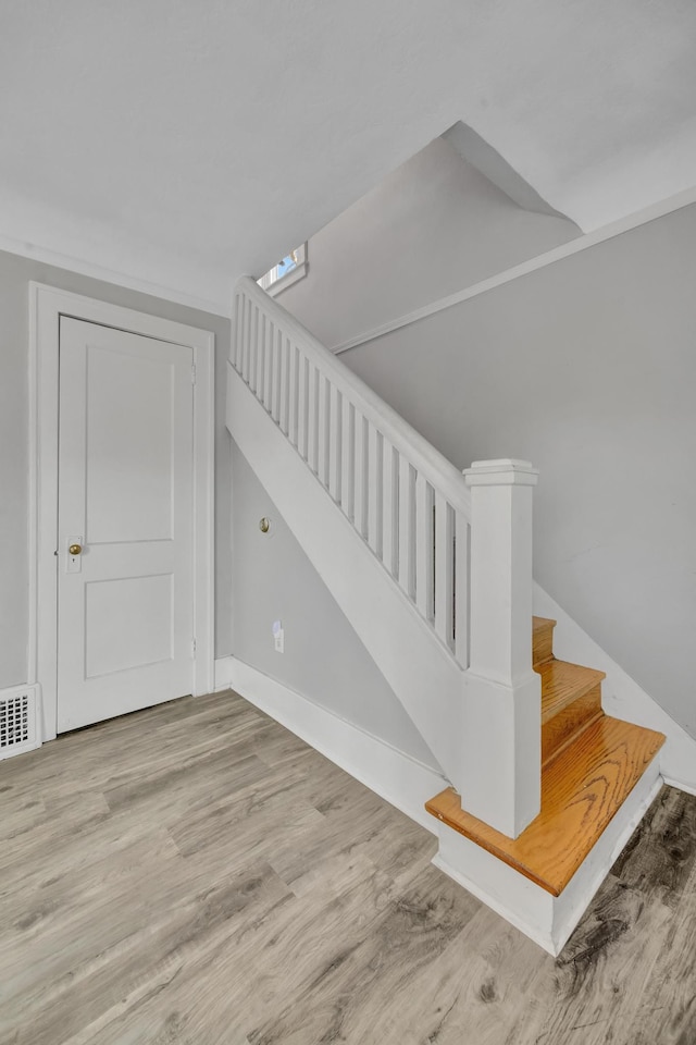 stairs with hardwood / wood-style floors