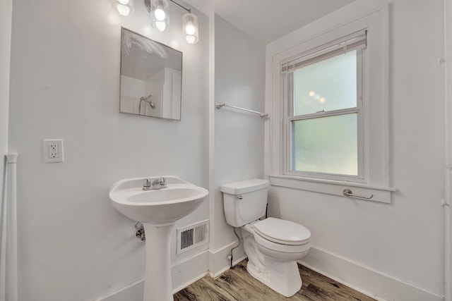 bathroom with wood-type flooring and toilet