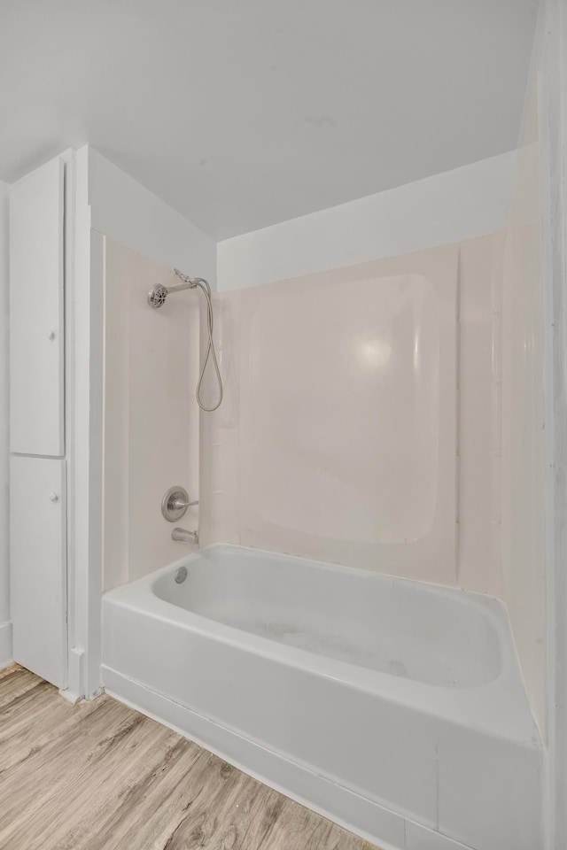 bathroom with hardwood / wood-style floors and shower / bathing tub combination