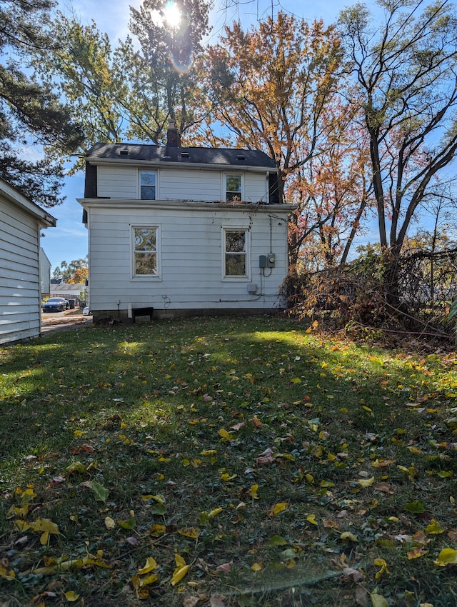 rear view of house with a yard