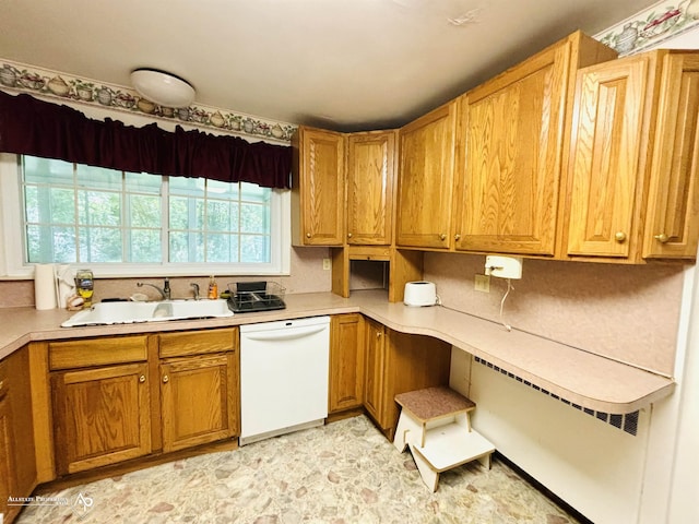 kitchen featuring a sink, brown cabinetry, white dishwasher, and light countertops