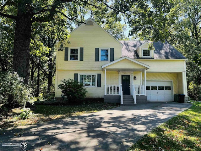 view of front of home featuring a porch, a garage, and driveway