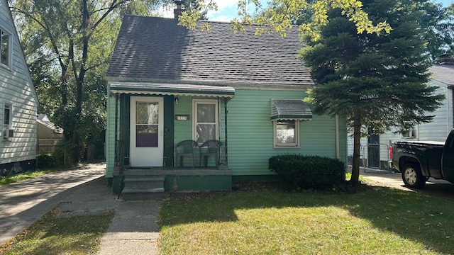 18736 Kenosha St, Harper Woods, MI 48225 - view of front of home featuring a front yard and roof with shingles