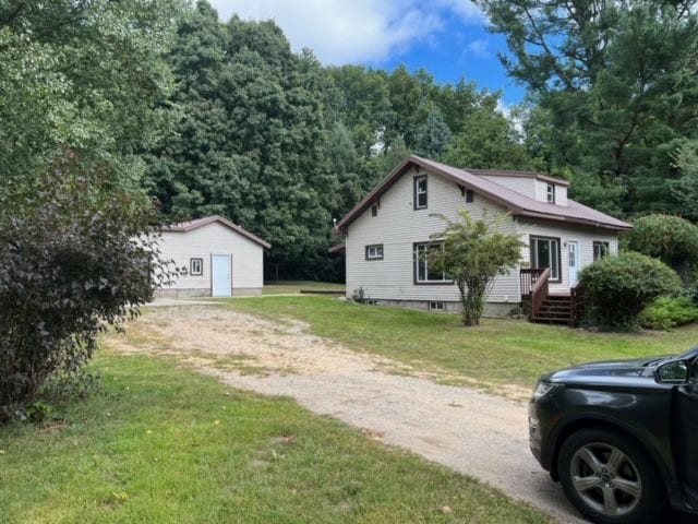 view of front of home with an outbuilding and a front yard