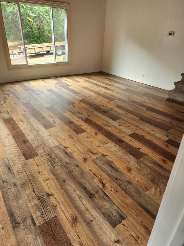 unfurnished room with wood-type flooring