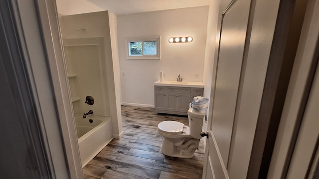 full bathroom with shower / bathing tub combination, hardwood / wood-style floors, vanity, and toilet