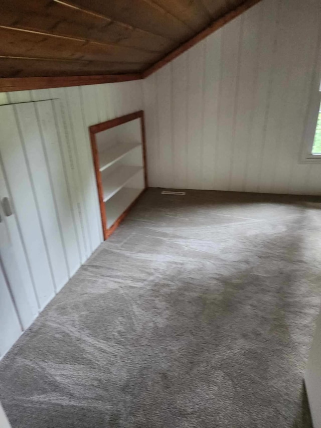 interior space featuring carpet floors and wood ceiling