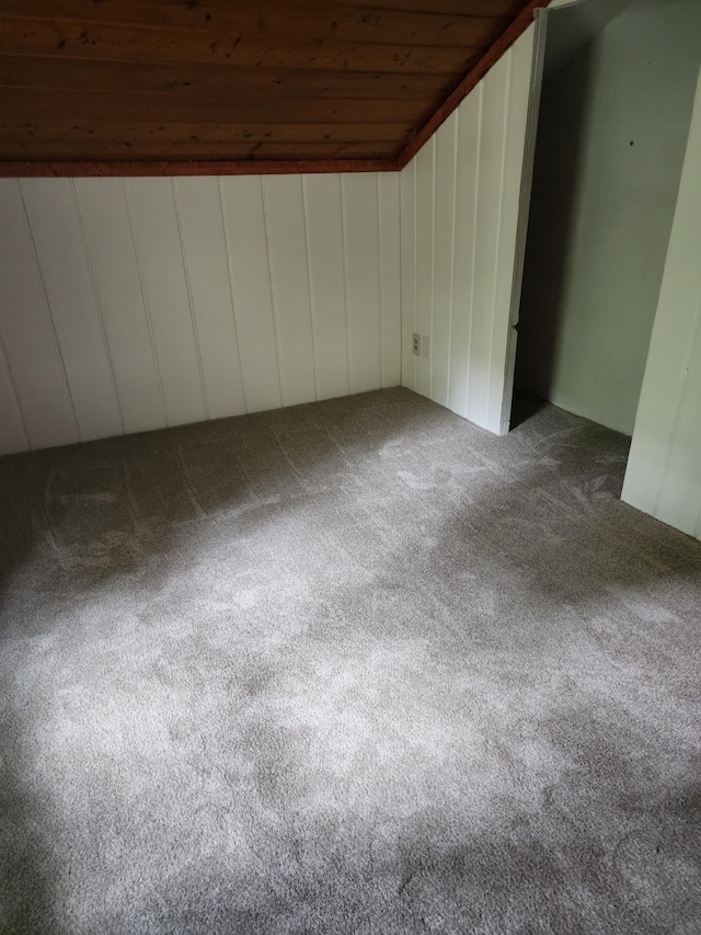 additional living space with carpet flooring, lofted ceiling, and wood ceiling