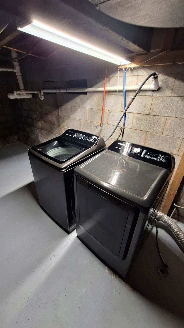 clothes washing area with independent washer and dryer