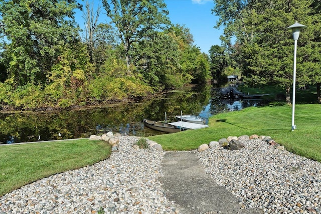 exterior space with a boat dock and a water view